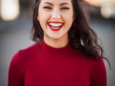 Professional woman smiling in red - Detroit property management